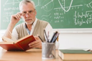 1588587820_old-teacher-looking-camera-school_23-2148201040